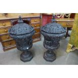 A pair of carved wooden faux bronze Campana lidded urns