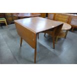 A teak drop-leaf table