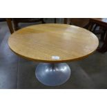 A circular light oak and steel based occasional table