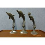 Three brass dolphin ornaments