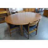 A teak extending dining table and four chairs