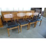 A set of four teak and vinyl chairs