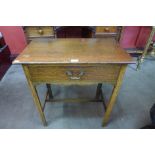 An early 20th century oak single drawer side table