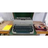 A Remington Quiet-Riter typewriter, accessories and book **PLEASE NOTE THIS LOT IS NOT ELIGIBLE