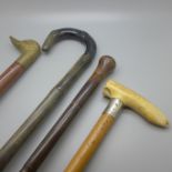 Four assorted walking sticks, one horn in the form of bamboo, one with silver collar