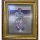 A signed Peter Shilton photograph in Nottingham Forest kit, taken with the European Cup, framed