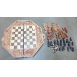 A games box with four legs and a carved chess set **PLEASE NOTE THIS LOT IS NOT ELIGIBLE FOR POSTING