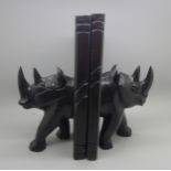 A pair of ebonised carved rhinoceros bookends