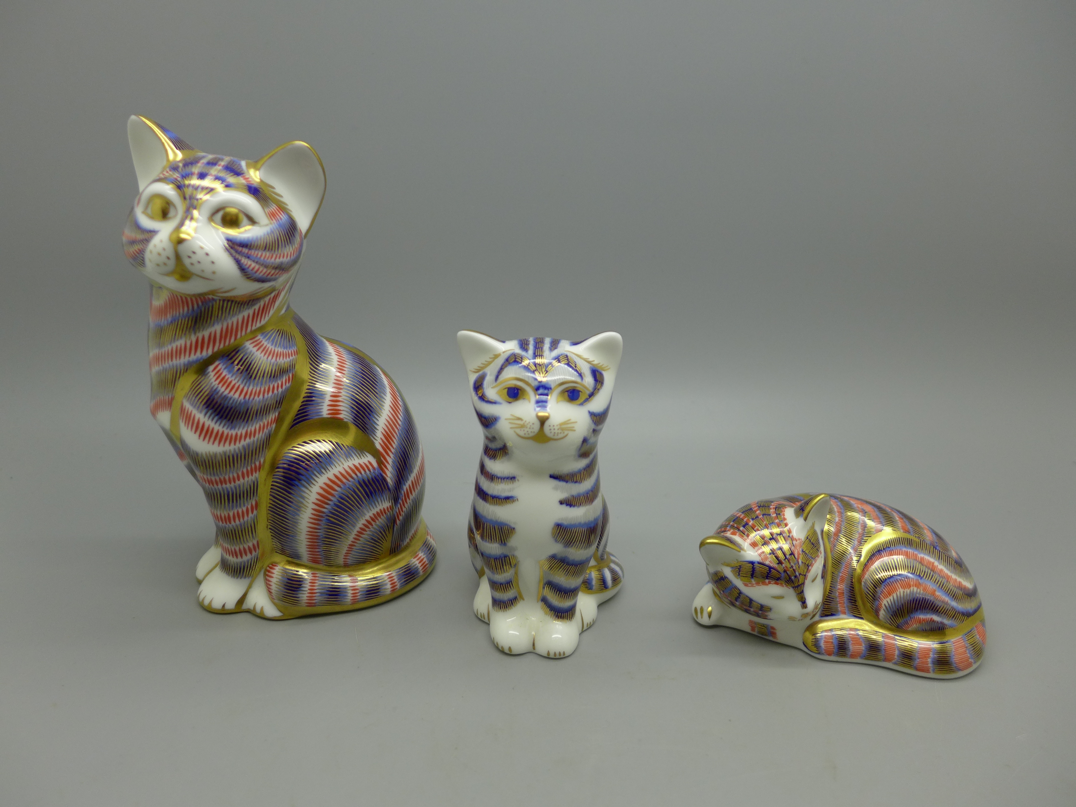 Three Royal Crown Derby paperweights, cats, all with stoppers