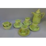 A Clarice Cliff Bizzare coffee set, four cups (one cup, chip to rim, one cup handle re-glued),