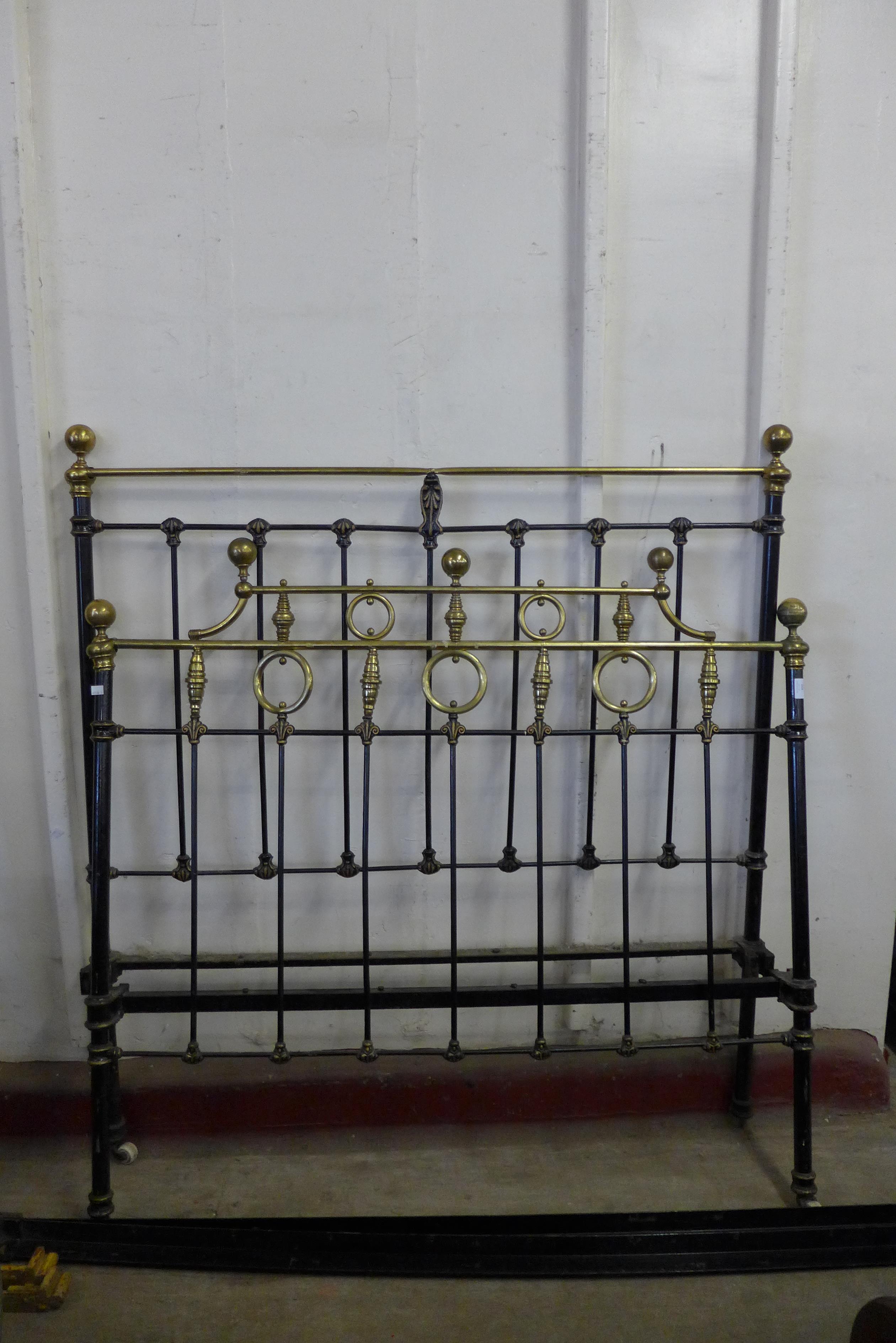 A Victorian cast iron and brass double bed