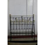A Victorian cast iron and brass double bed