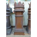 A Victorian terracotta crown glazed chimney pot