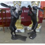 A pair of large bronze figures of boxing hares