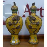 A pair of Chinese Imperial yellow champleve enamelled and copper mounted vases and covers