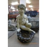 A figural Cherub concrete bird bath