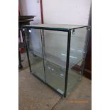 A glass two-door counter top shop cabinet