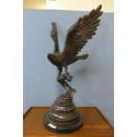 A large French style bronze figure of an eagle, on black marble socle