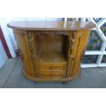 A French style carved walnut demi lune side cabinet