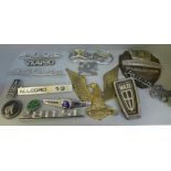 A collection of assorted car badges and a plaque