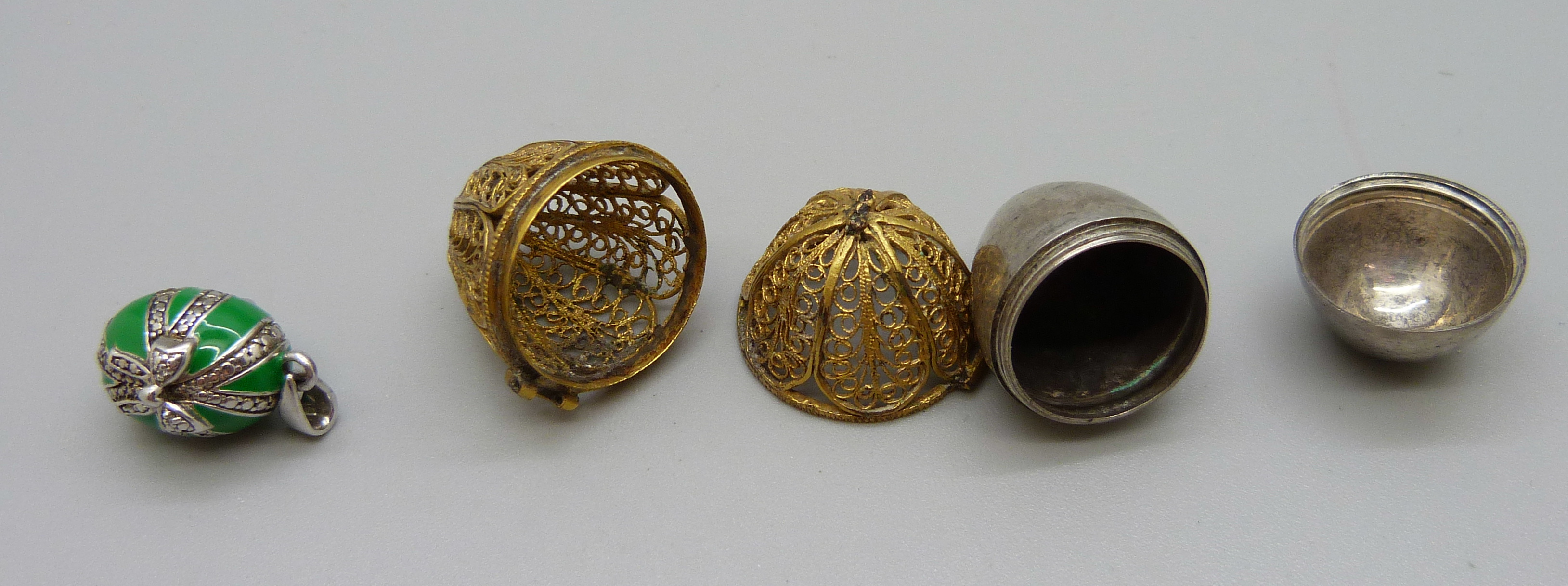 A silver gilt filigree egg thimble holder, hinge requires repair and a silver mounted pendant - Image 2 of 2