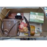 A box containing assorted items including a pair of ice skates and a wagon and horses novelty