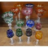 Fourteen Bohemian liqueur and hock glasses with fine detailing on multi-coloured bowls with clear