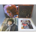 A collection of eleven Bob Dylan LP records (three gatefold) and three Woody Guthrie LP records