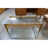 A teak and glass topped coffee table