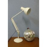 A white metal anglepoise desk lamp and a mirrored disco ball