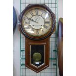 A 19th Century American Ansonia Clock Co. walnut wall clock, enamelled dial signed C. B. Sturgess,