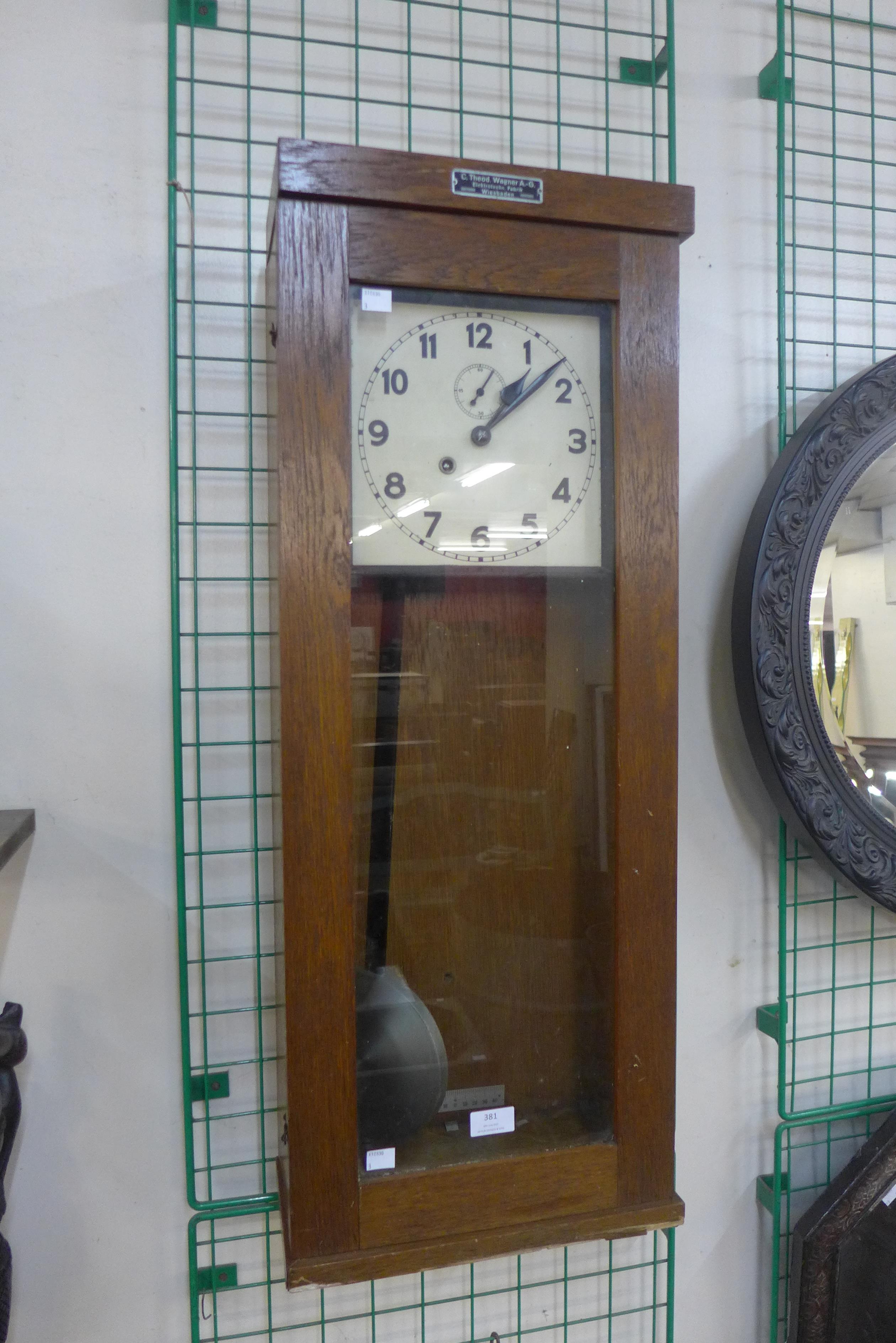 A German oak master slave wall clock