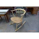 An Ercol elm and beech 338 model fireside cowhorn rocking chair