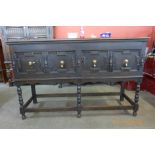 An early 20th Century Jacobean Revival oak geometric moulded dresser