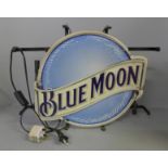 A neon sign, 'Blue Moon'