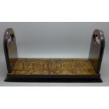 An early 19th Century burr elm book slide, marked Betjemann's on the hinge, retailer's brass