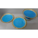 A Minton comport and a pair of plates decorated in blue and gilt border