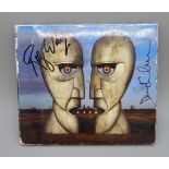A Pink Floyd autographed CD, The Division Bell signed by David Gilmour and Roger Waters