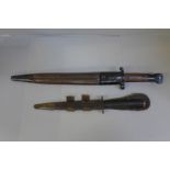A WWI bayonet and a Commando knife, both with scabbards