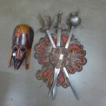 A sword wooden carved plaque and an African mask