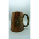 An embossed copper mug