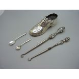 A novelty silver shoe pin cushion, a/f, two button hooks and two silver salt spoons