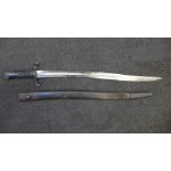 A Victorian military bayonet with scabbard, marks including WD with broad arrow