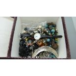 A box of costume jewellery and wristwatches including an amber pendant and chain