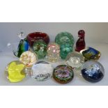 Fourteen items of glass comprising ten glass paperweights, a heavy ruby red controlled glass