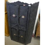 An Indian heavily carved four door cupboard