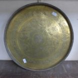 A Persian brass circular plaque