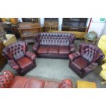 An oxblood leather Chesterfield style three piece suite