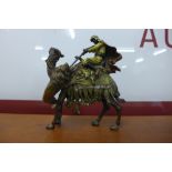 A cold painted bronze figure of a man and camel, in the manner of Bergman