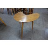 A teak boomerang shaped occasional table